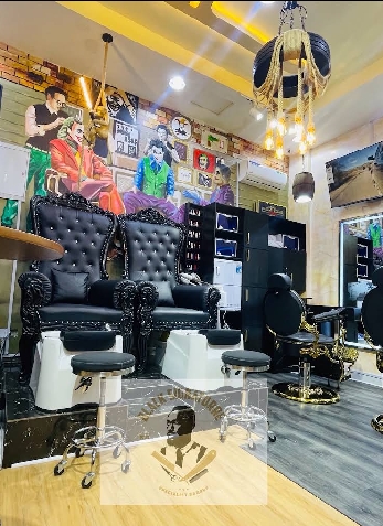 Signature black throne chairs, gold-based barber chairs and pedicure basins at Black Signature Barber's Lounge